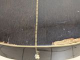 a close up of a guitar case with a string attached to it