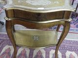 a small table with a drawer on it in a room
