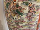a large vase with a painting on it sitting on a table