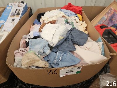 two boxes of clothes that are sitting in a trash can