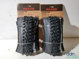 two maxxis tires are on display in a box