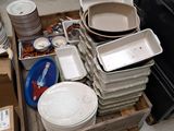 a lot of plates and pans sitting in a box