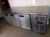 a stainless steel counter top with three doors and a freezer