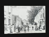 black and white photograph of a group of people walking down a street