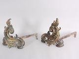 two ornate metal brackets on a white surface