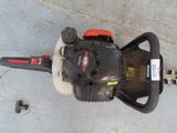 a chainsaw that is sitting on the ground