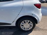 a small white car parked in a parking lot