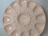 a plate that is sitting on a table next to a vase