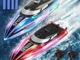 two remote control boats in the water with lights and remote controls