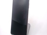 a cell phone that is sitting on top of a stand