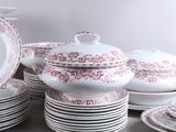 a lot of plates and bowls on the table