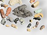 many different types of figurines displayed on a white surface