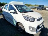 a small white car that is parked in a lot