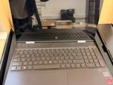 a laptop computer sitting on a table with a person taking a picture