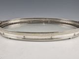 a silver tray with handles and handles on a white surface