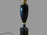 a black lamp with a gold base and a blue shade