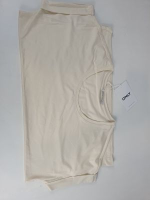 beige t - shirt laying on top of a white table with a tag on it
