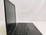 the back of a laptop computer sitting on top of a white table