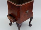 a small wooden planter with a drawer on it