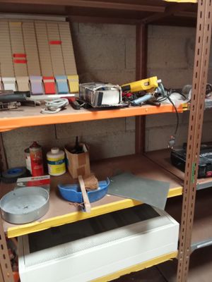 a shelf full of tools and other items in a room