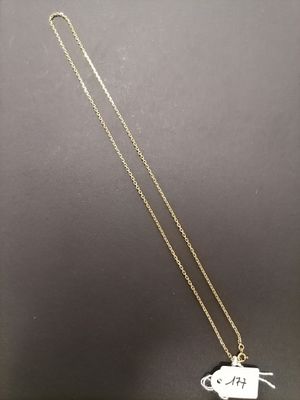 a gold necklace with a small elephant on it ' s back