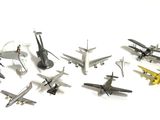 a lot of toy airplanes that are on a white surface