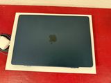 an apple macbook pro laptop with a mouse on top of it