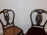 two chairs sitting next to each other in a room