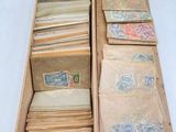 an old wooden box filled with lots of old stamps and envelopes