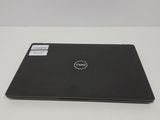 the dell laptop is sitting on a table with its lid open