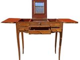 a small wooden table with a mirror on top of it