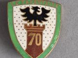 un gros plan d'un insigne représentant un aigle perché au sommet d'une tour