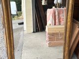 a mirror that is sitting on the ground next to a pile of boxes