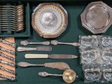 a green tray with silverware and silverware in it