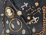 an assortment of religious items including a cross, rosary, and other religious items