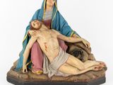 an image of a statue of jesus laying on the cross