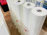 many rolls of white paper on a table in a room