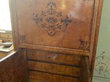 a very old wooden cabinet with a drawer in it