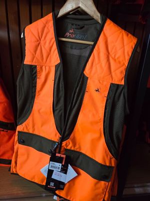 an orange vest with a tag on it sitting on a shelf