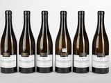 six bottles of wine are lined up in a row