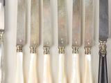 several different types of knives and knives are lined up on a white surface