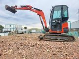 a small excavator that is sitting in the dirt