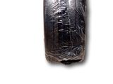 an image of a piece of black plastic wrapped in plastic