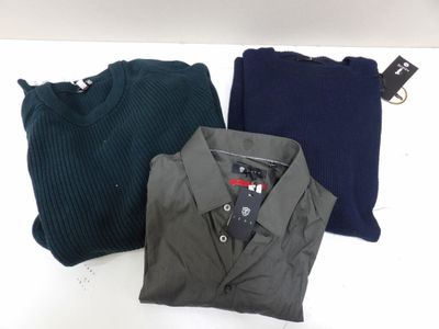 three men ' s sweaters sitting on top of a white table