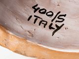 a close up of a bowl with a name written on it