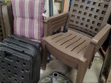 a chair and a suitcase sitting next to each other on the floor
