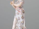 a figurine of a woman playing a flute