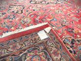 a red carpet with a floral design on it and a tag on the floor
