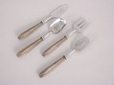 four forks and spoons sitting on top of a white table