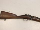 a close up of a rifle mounted on a wall on a table